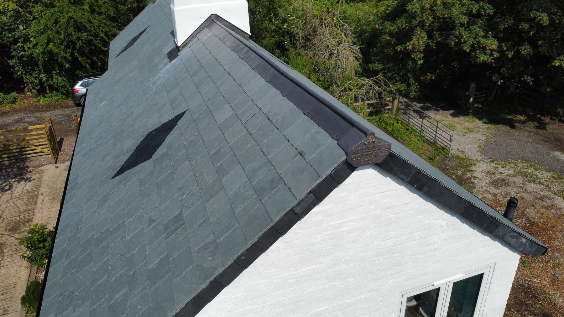 Aerial view of completed slate roof and chimney leadwork